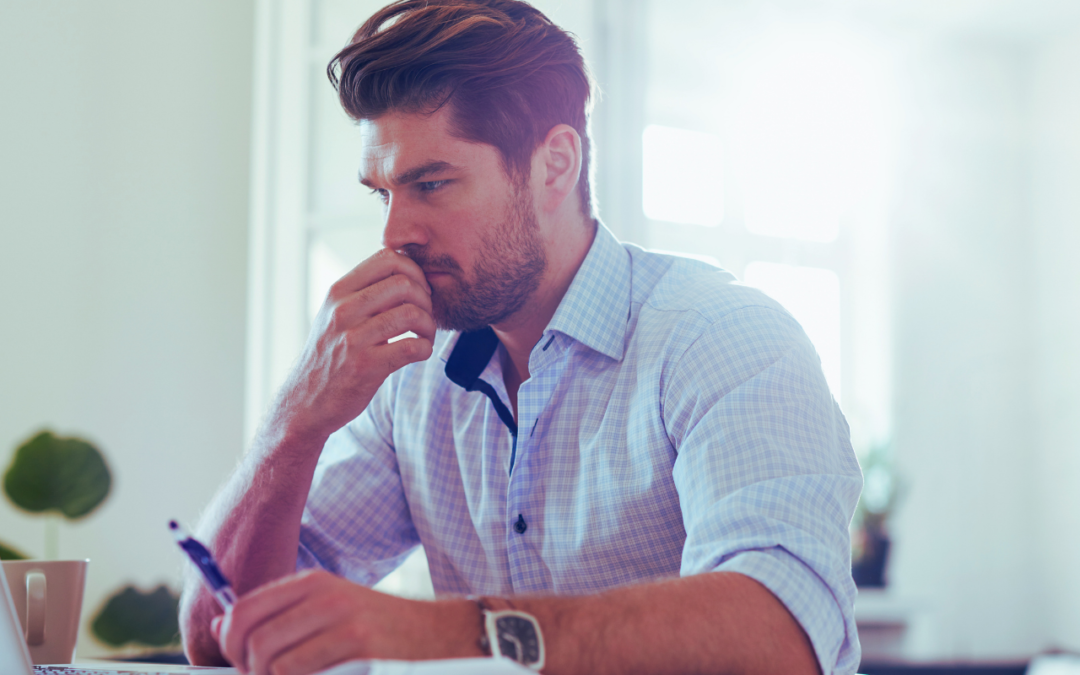 The hardest hire after the founding team - Photo of business owner thinking through a decision.