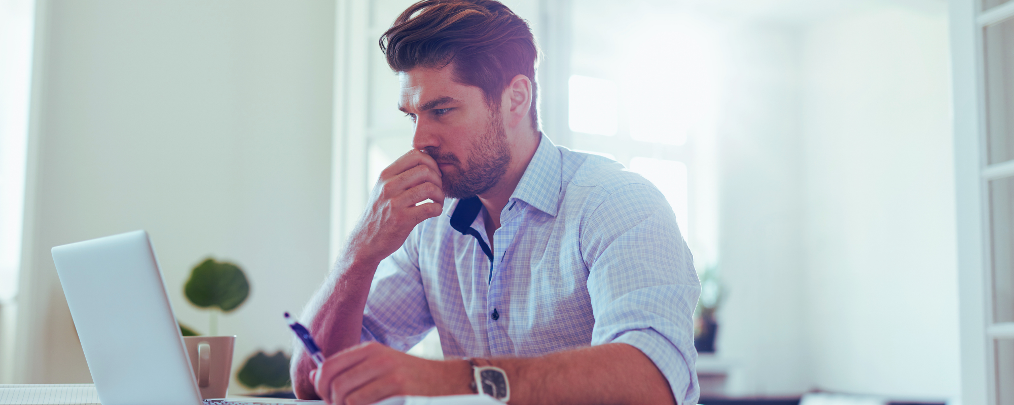The hardest hire after the founding team - Photo of business owner thinking through a decision.